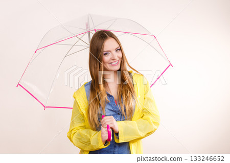 Woman wearing waterproof coat under umbrella 133246652