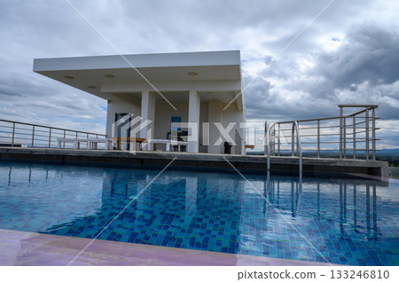 Stunning rooftop oasis with shimmering pool and panoramic sky view at sunset Stunning rooftop oasis with shimmering pool and panoramic sky view at sunset 133246810