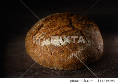 Freshly baked rustic bread resting on a wooden surface, capturing the essence Freshly baked rustic bread resting on a wooden surface, capturing the essence 133246869