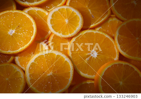 Freshly sliced oranges create a vibrant display of citrus beauty in a sunny kitchen Freshly sliced oranges create a vibrant display of citrus beauty in a sunny kitchen 133246903