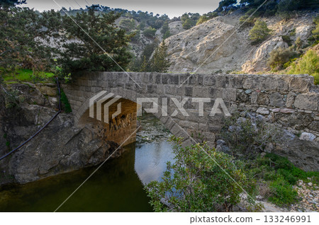 Exploring ancient stone bridge hidden in a serene natural landscape Exploring ancient stone bridge hidden in a serene natural landscape 133246991