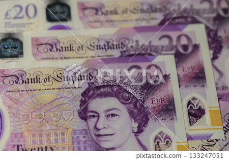 Colorful twenty-pound notes showcasing the intricate details of UK currency design and royal imagery Colorful twenty-pound notes showcasing the intricate details of UK currency design and royal imagery 133247051