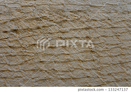 Textured wall brings rustic charm to urban environment during sunny afternoon Textured wall brings rustic charm to urban environment during sunny afternoon 133247137