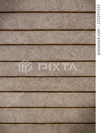 Textured wall reveals layers of simplicity and elegance under soft ambient light Textured wall reveals layers of simplicity and elegance under soft ambient light 133247152