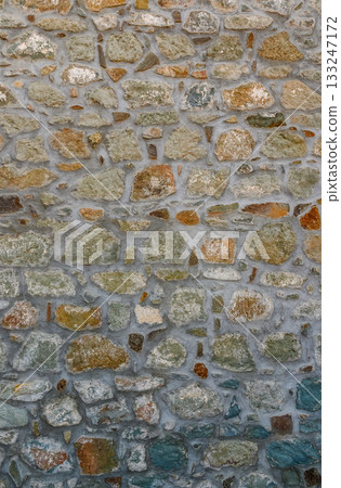 Stone wall with a beautiful array of colors reflecting light during a sunny afternoon Stone wall with a beautiful array of colors reflecting light during a sunny afternoon 133247172
