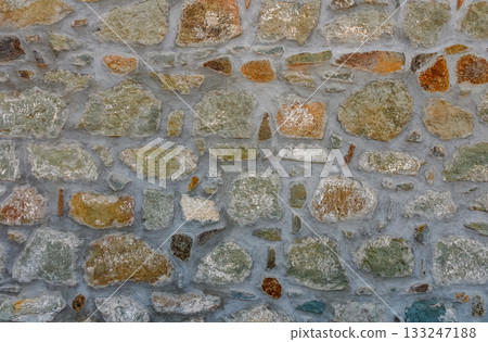 Exploring textures and colors of an ancient stone wall in a quaint village during golden hour Exploring textures and colors of an ancient stone wall in a quaint village during golden hour 133247188