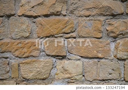 Hidden stories within the ancient stone wall reveal the passage of time in a historic site 133247194