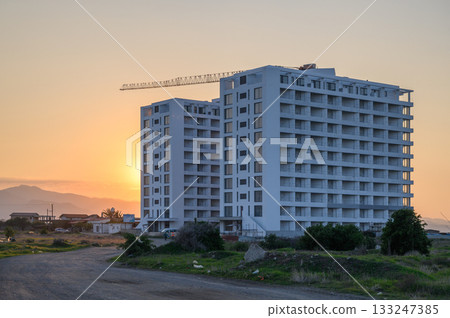 New urban development rises against a stunning sunset in a tranquil landscape 133247385