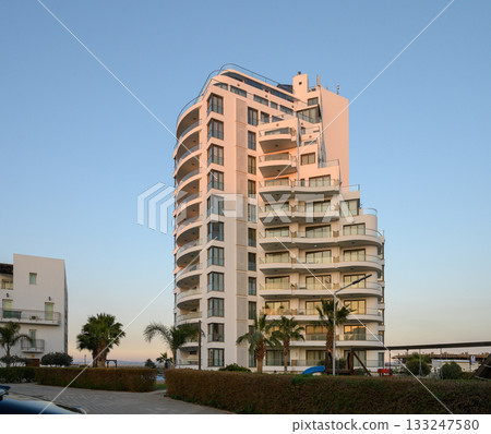 Modern architecture shines at sunset in a coastal residential complex 133247580