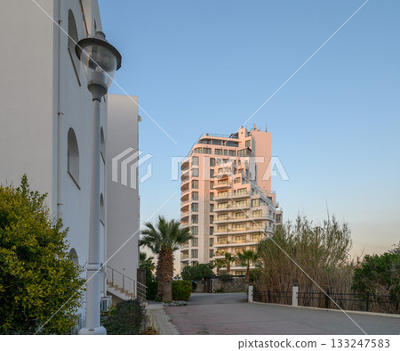 Modern architecture rises against a tranquil evening sky in a coastal retreat 133247583