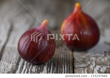 Fresh ripe fig lying on rustic wooden table 133247666