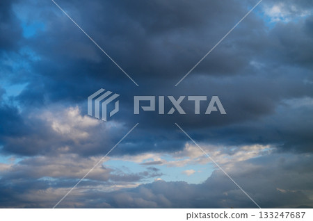 Majestic twilight clouds gathered over a serene evening sky at dusk 133247687