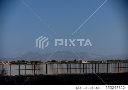 Construction fence with mountain backdrop in Cyprus Construction fence with mountain backdrop in Cyprus 133247812