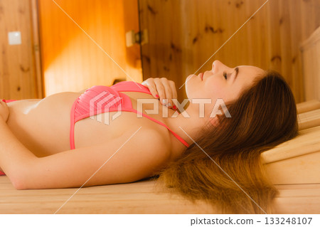 Young woman relaxing in sauna. Spa wellbeing 133248107