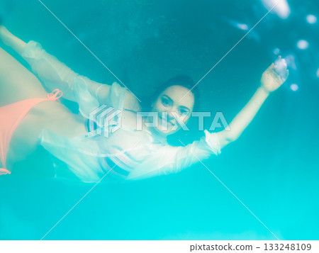 Underwater girl wearing bikini in swimming pool 133248109