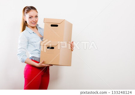 Woman moving into apartment house carrying boxes. Woman moving into apartment house carrying boxes. 133248124