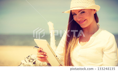 Girl with tablet on seaside. Girl with tablet on seaside. 133248135