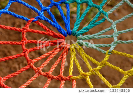 Colorful knots intertwine in a vibrant rope structure creating an artistic web of creativity 133248306