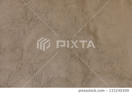 Rough textures of adobe walls reveal the beauty of traditional craftsmanship in a sunlit desert landscape 133248309