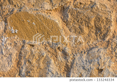 Textures of ancient stone walls showcasing nature's artistry in warm hues Textures of ancient stone walls showcasing nature's artistry in warm hues 133248334