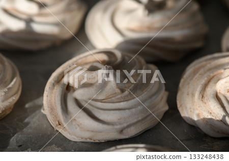 Swirls of meringue drying in warm sunlight at a cozy kitchen setting Swirls of meringue drying in warm sunlight at a cozy kitchen setting 133248438
