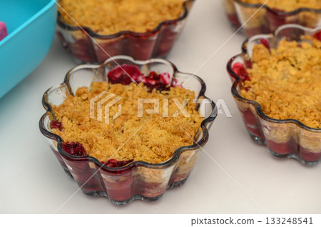 Delightful cherry crumble cups baked to perfection with a golden topping and rich berry flavor 133248541