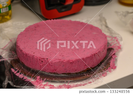 Delightful pink dessert cooling on the counter after being freshly made in the kitchen 133248556