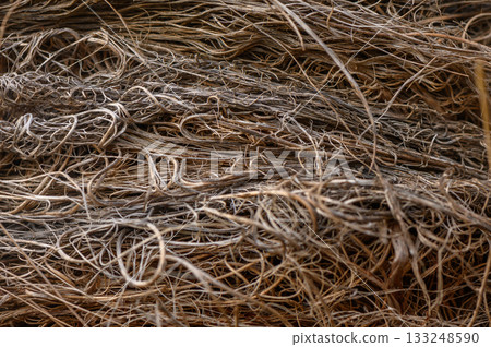 Natural fibers intertwine to create a textured tapestry in a sunlit workspace during the afternoon hours Natural fibers intertwine to create a textured tapestry in a sunlit workspace during the afternoon hours 133248590