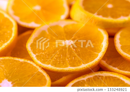 Vibrant slices of fresh oranges arranged beautifully on a bright surface Vibrant slices of fresh oranges arranged beautifully on a bright surface 133248921