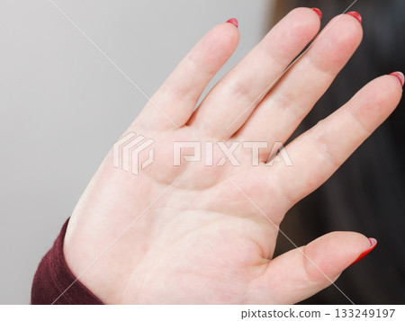 Woman showing stop hand sign gesture. 133249197