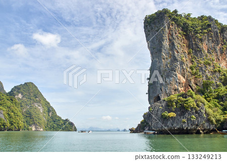 Scenic tropical limestone cliffs and calm sea in thailand s phang nga bay Scenic tropical limestone cliffs and calm sea in thailand s phang nga bay 133249213