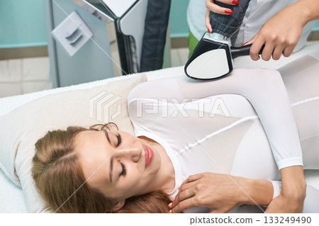 Caucasian female adult receiving laser treatment in spa clinic 133249490