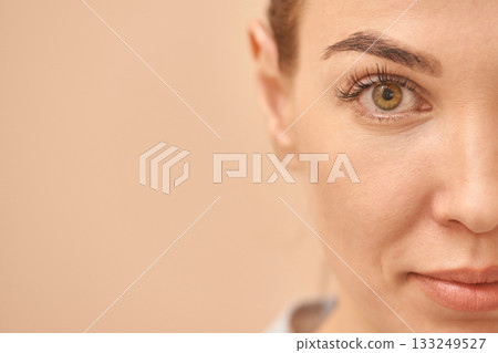 Partial face of young caucasian female with focused eye and natural makeup 133249527