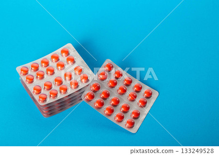 Stacks of blisters with red vitamin tablets. Top view. Multivitamin complex for health. Copy space for text 133249528