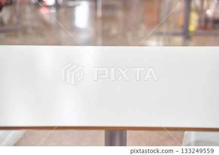 Empty modern table in bright indoor setting with blurred background 133249559
