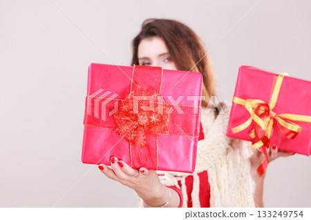 Woman holds red christmas gift boxes 133249754