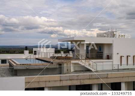 Modern architecture captures a stunning rooftop retreat with panoramic views at sunset 133249755