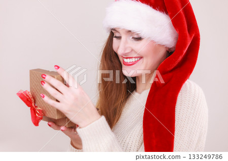 Woman opening gift box. Christmas time Woman opening gift box. Christmas time 133249786