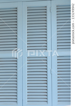 Light blue wooden shutters create a refreshing atmosphere on a sunny day by the coastal villa near the beach 133249942