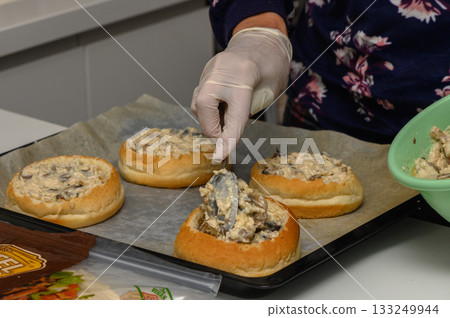 Delicious hand-prepared buns filled with creamy mushroom mixture in a cozy kitchen setting 133249944