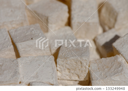 Cubes of fresh organic tofu ready for culinary creativity in a kitchen setting Cubes of fresh organic tofu ready for culinary creativity in a kitchen setting 133249948