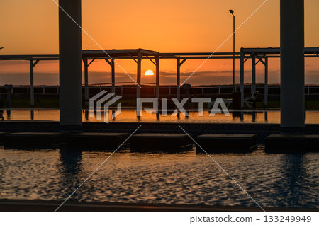Family enjoys a sunny day at the park while playing frisbee and having a picnic on a warm summer afternoon Family enjoys a sunny day at the park while playing frisbee and having a picnic on a warm summer afternoon 133249949