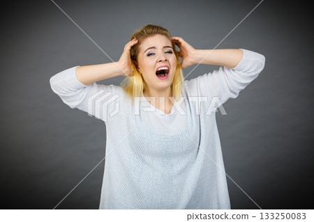Unhappy woman screaming and yelling in pain Unhappy woman screaming and yelling in pain 133250083
