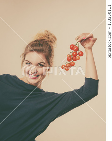 Woman holding fresh cherry tomatoes Woman holding fresh cherry tomatoes 133250111
