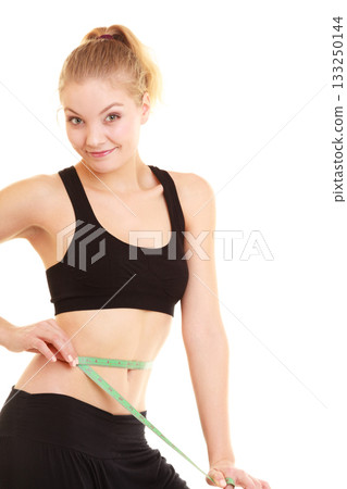 diet. slim blonde girl with measure tape measuring waist diet. slim blonde girl with measure tape measuring waist 133250144