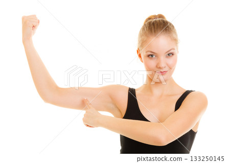 Fitness woman showing energy flexing biceps muscles. Fitness woman showing energy flexing biceps muscles. 133250145