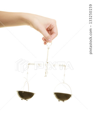 Law court. Female hand holds scales symbol of justice. 133250159