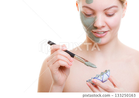 Woman applying face mask with brush Woman applying face mask with brush 133250163