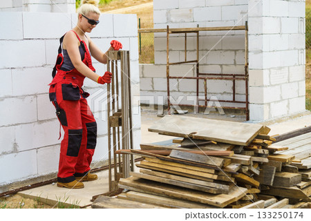 Woman working with pallets on construction site 133250174