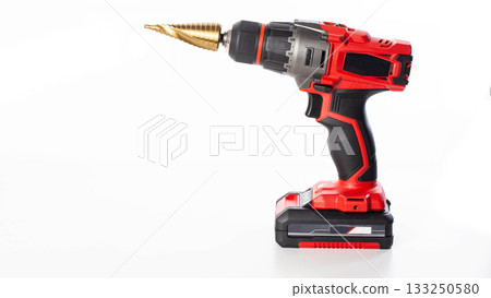 Modern red drill screwdriver with step drill bit in keyless chuck on white background, close-up Modern red drill screwdriver with step drill bit in keyless chuck on white background, close-up 133250580